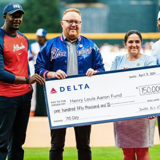Ceremonial donation check presentation supporting the Henry Louis Aaron Fund.